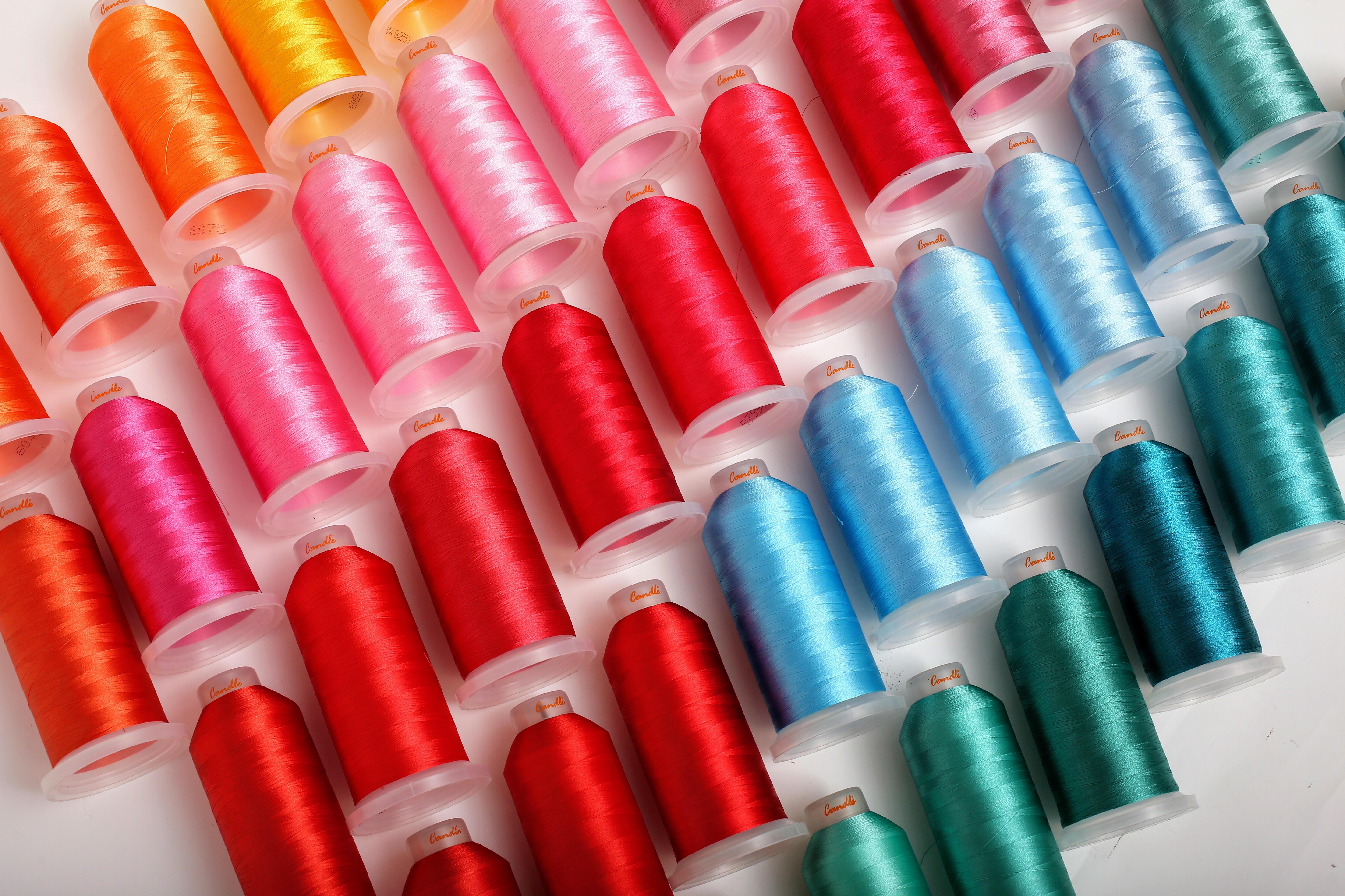 Colorful sewing thread cones in red, blue, and green arranged together